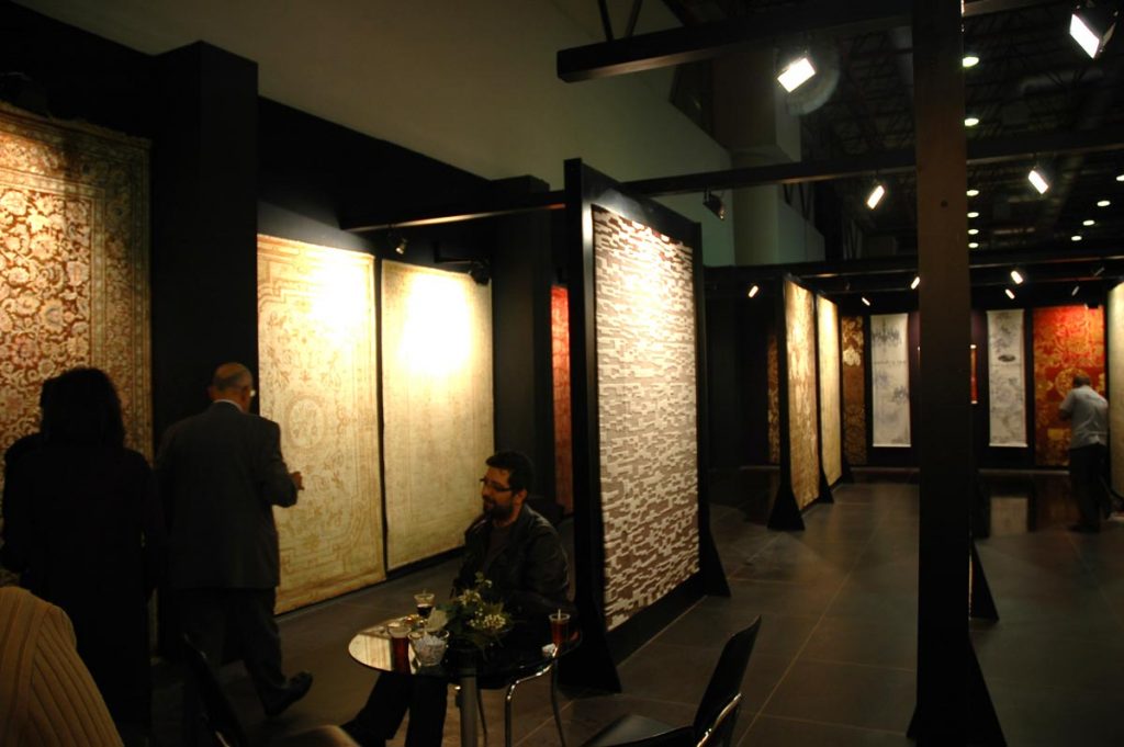 Rugs vertically installed on a dark Expo showroom