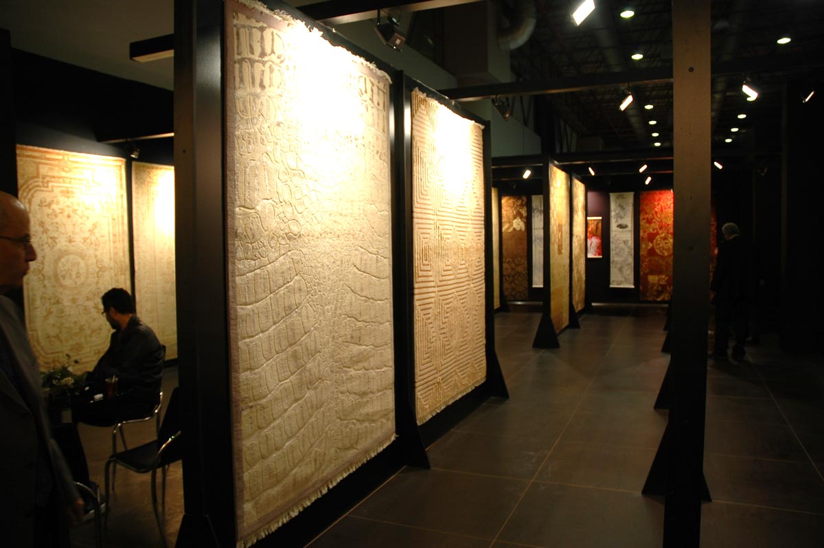 Rugs displayed under light on a Black Exhibition Stand