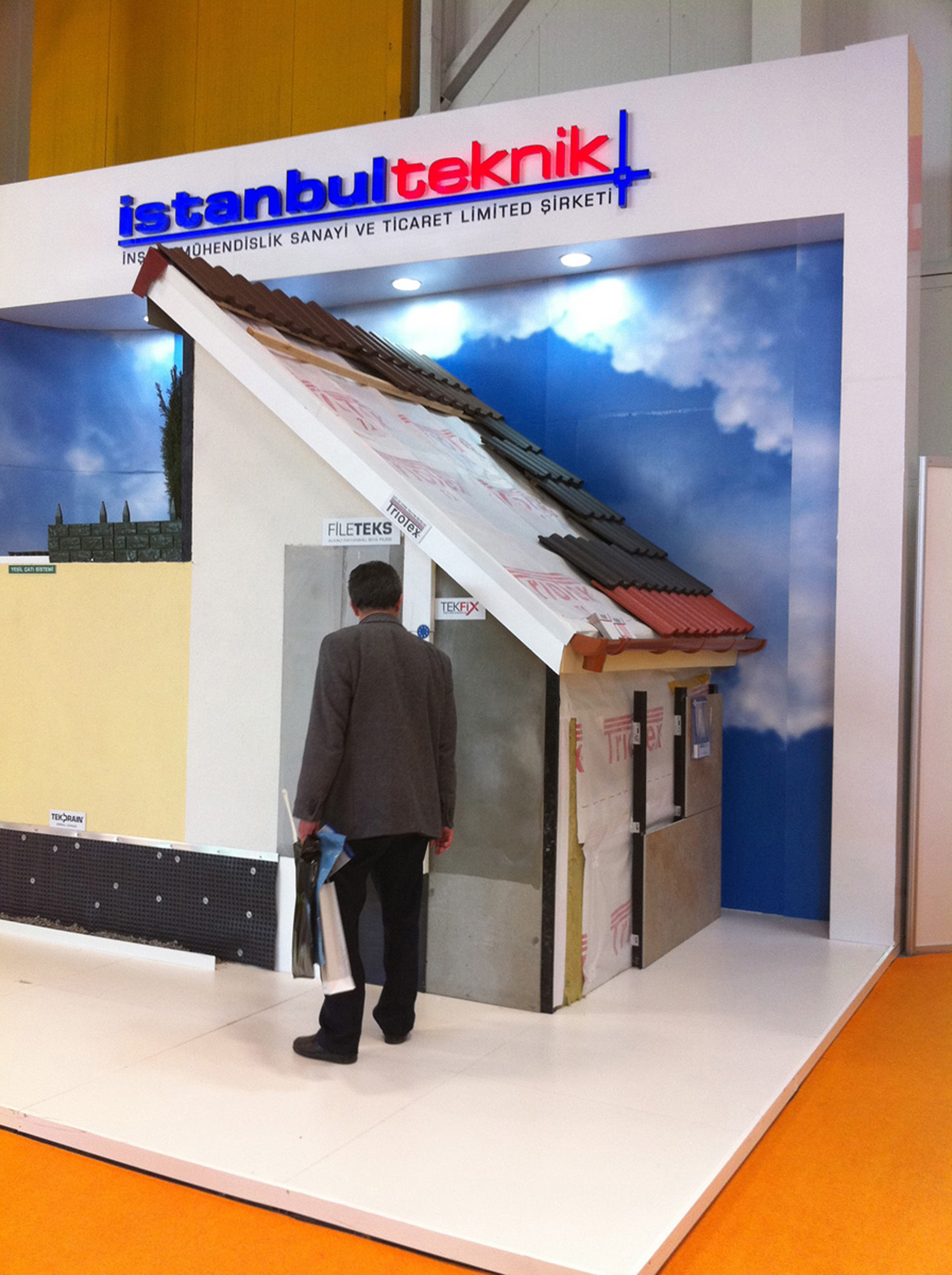 A man standing on an exhibition booth