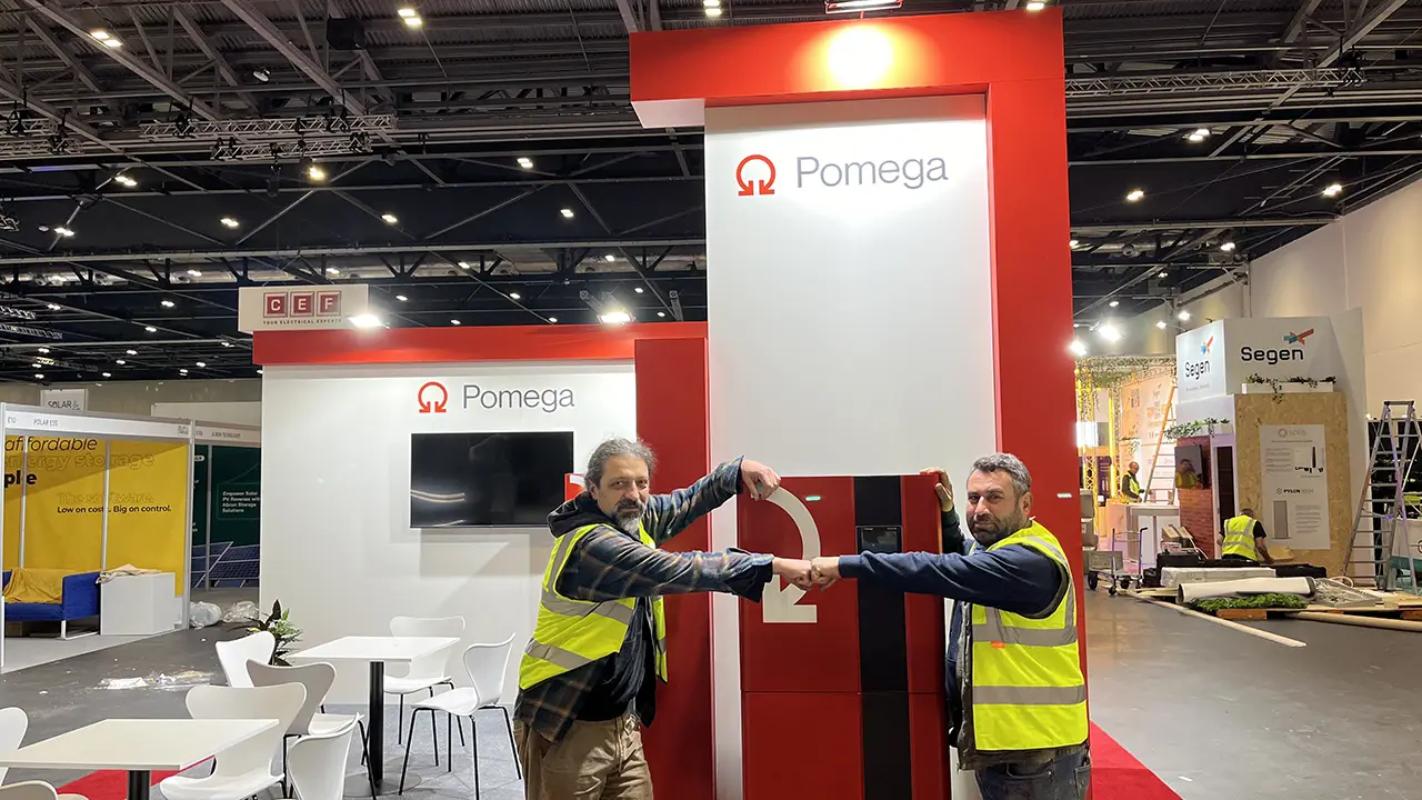 Two Exhibition booth workers holding hands